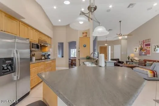 a kitchen with stainless steel appliances granite countertop a stove top oven and sink