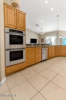 a large kitchen with granite countertop a sink and a stove top oven