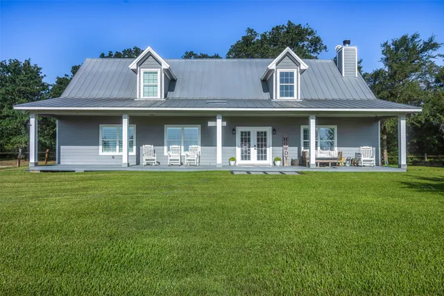 a front view of a house with a yard table and chairs