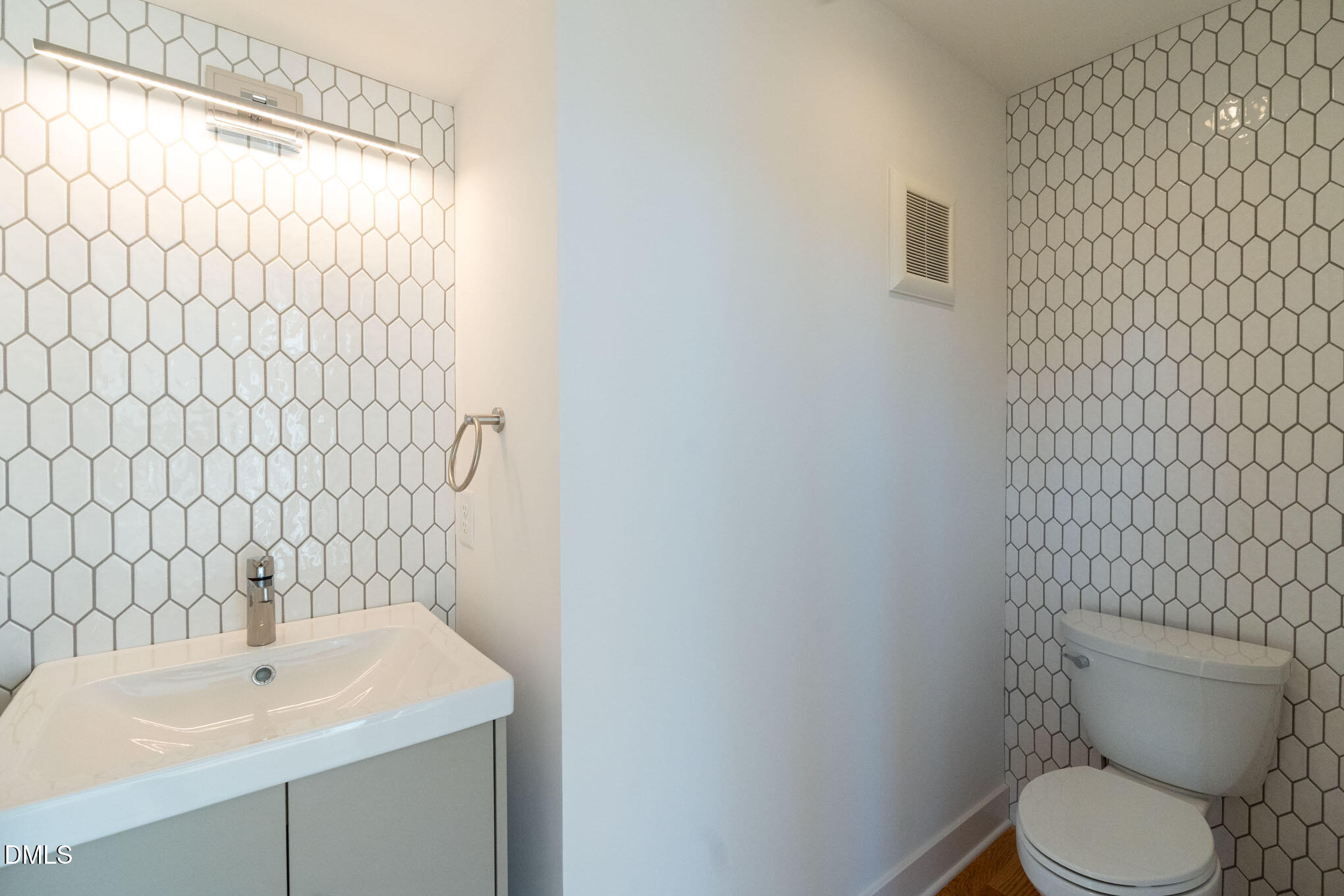 400 East Martin Street, Unit A Raleigh, NC 27601 - Photo 9 of 29 a bathroom with a sink a toilet and a mirror