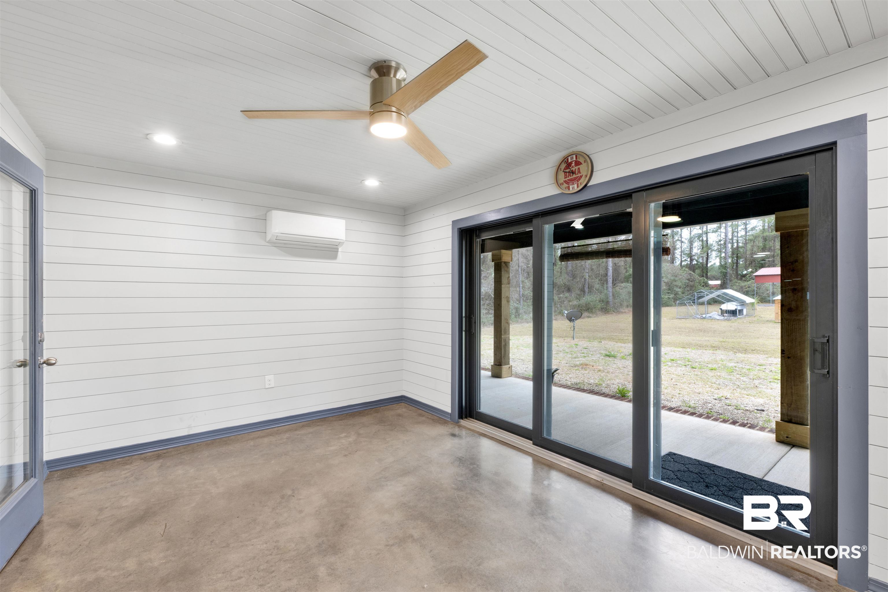 36397 Alexandria Trail Stapleton, AL 36578 - Photo 26 of 65 Empty room featuring finished concrete flooring, wooden walls, and ceiling fan