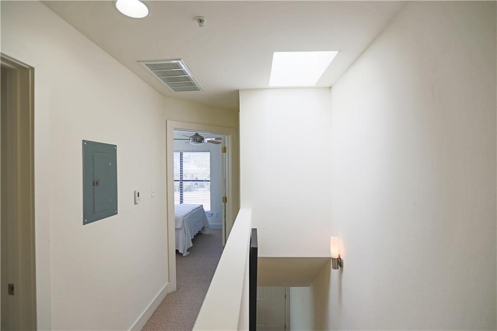 711 West 32nd Street, Unit 110 Austin, TX 78705 - Photo 11 of 24 a view of a hallway with wooden floor and entryway