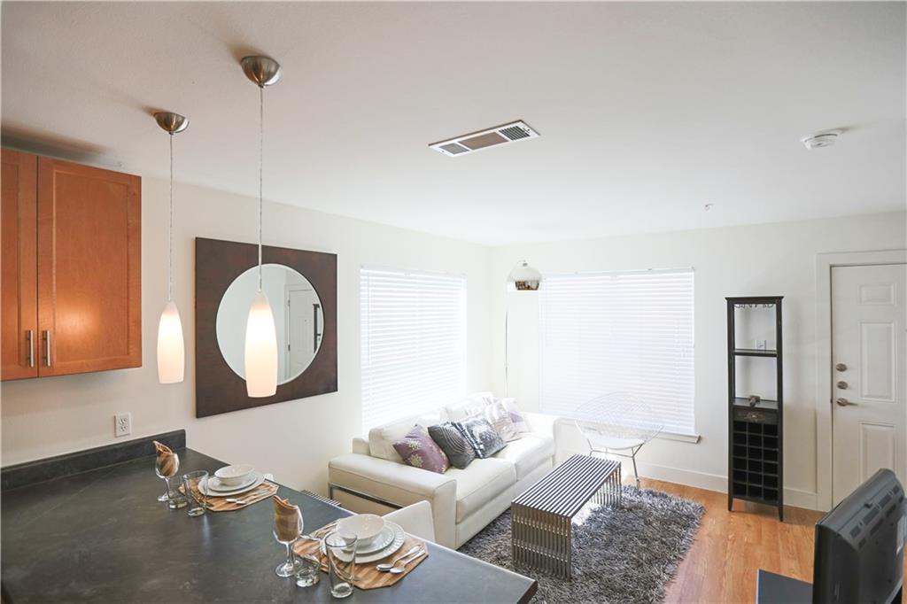 711 West 32nd Street, Unit 110 Austin, TX 78705 - Photo 5 of 24 a living room with furniture and a mirror
