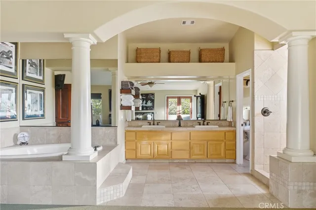 a view of a patio with a dining table and chairs with wooden floor and fence