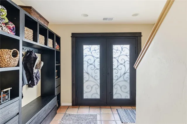 a living room with furniture gym equipment and a large window