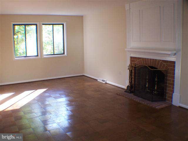 11807 Blue Spruce Road Reston, VA 20191 - Photo 3 of 30 a view of an empty room with a fireplace and a window