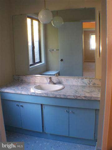 11807 Blue Spruce Road Reston, VA 20191 - Photo 22 of 30 a bathroom with a granite countertop sink and a mirror