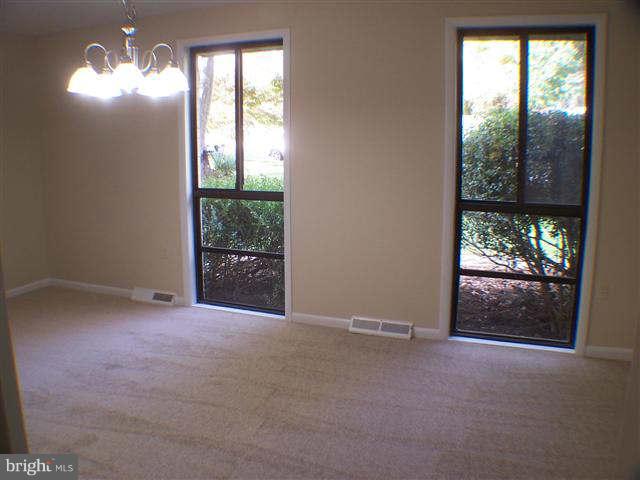 11807 Blue Spruce Road Reston, VA 20191 - Photo 5 of 30 an empty room with windows and outdoor view