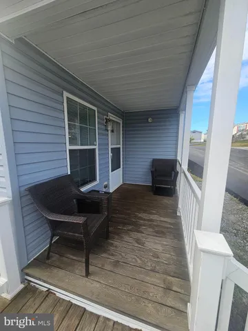 a balcony with furniture and a window