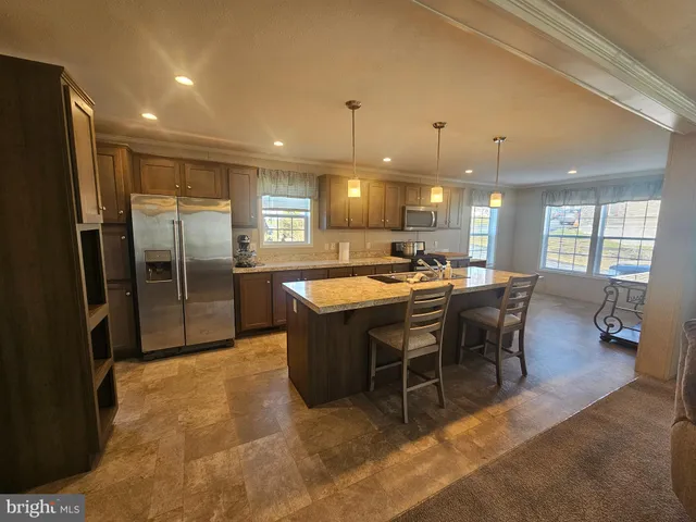 a large kitchen with a table and chairs