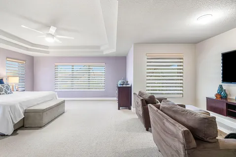 a bedroom with a bed and a couch