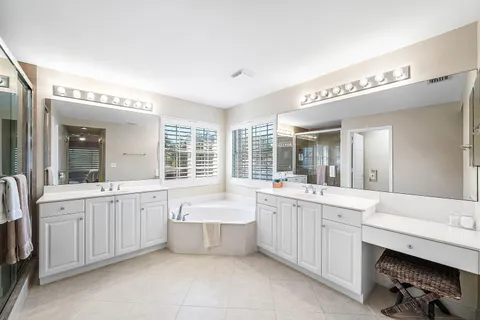 a large bathroom with a large tub and sink