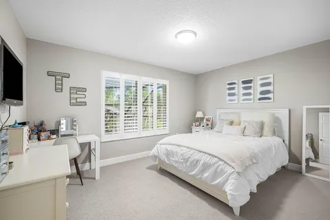 a bedroom with a bed and a desk