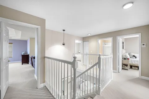 a view of a bedroom with wooden floor and windows