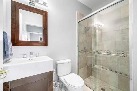 a bathroom with a toilet a sink and shower