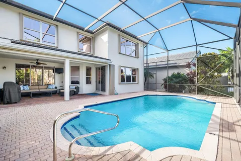 a swimming pool with outdoor seating yard and barbeque oven