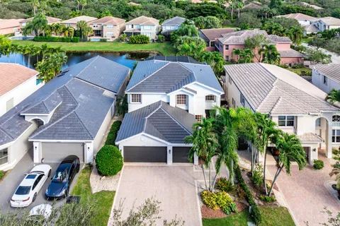 an aerial view of multiple houses with a yard