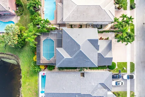 an aerial view of a house with a yard and potted plants