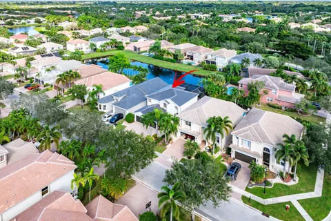 an aerial view of residential houses with outdoor space and street view