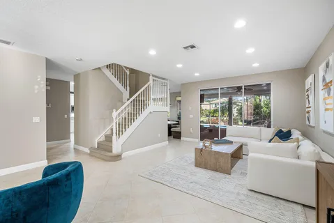 a living room with furniture and stairs