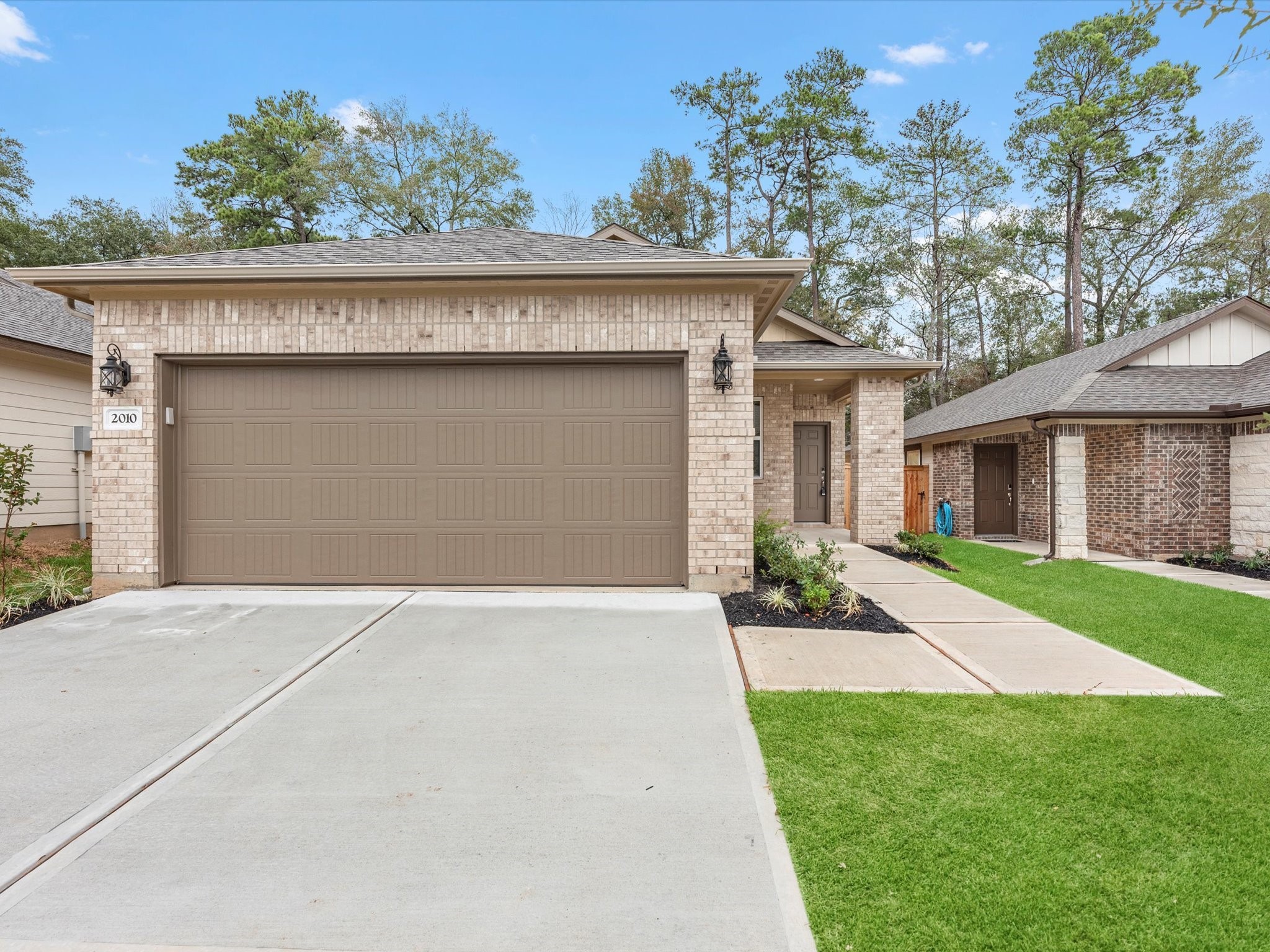 2010 West Darlington Oak Court Conroe, TX 77304 - Photo 4 of 26 front view of a house with a yard