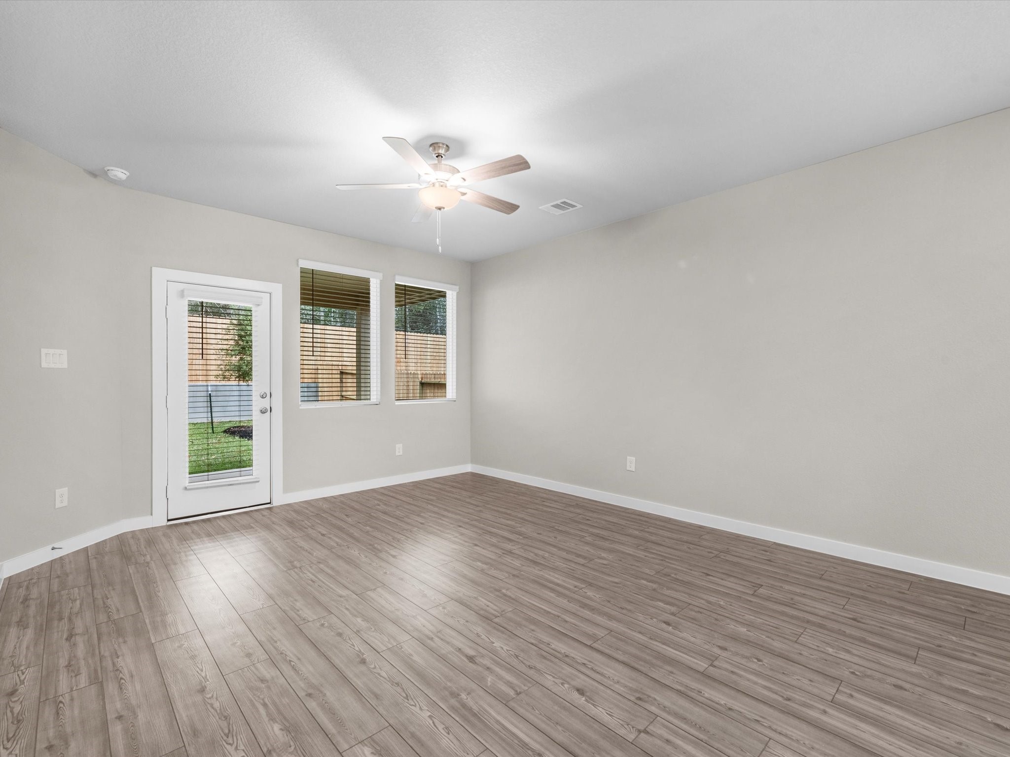 2010 West Darlington Oak Court Conroe, TX 77304 - Photo 8 of 26 a view of an empty room with wooden floor and a window