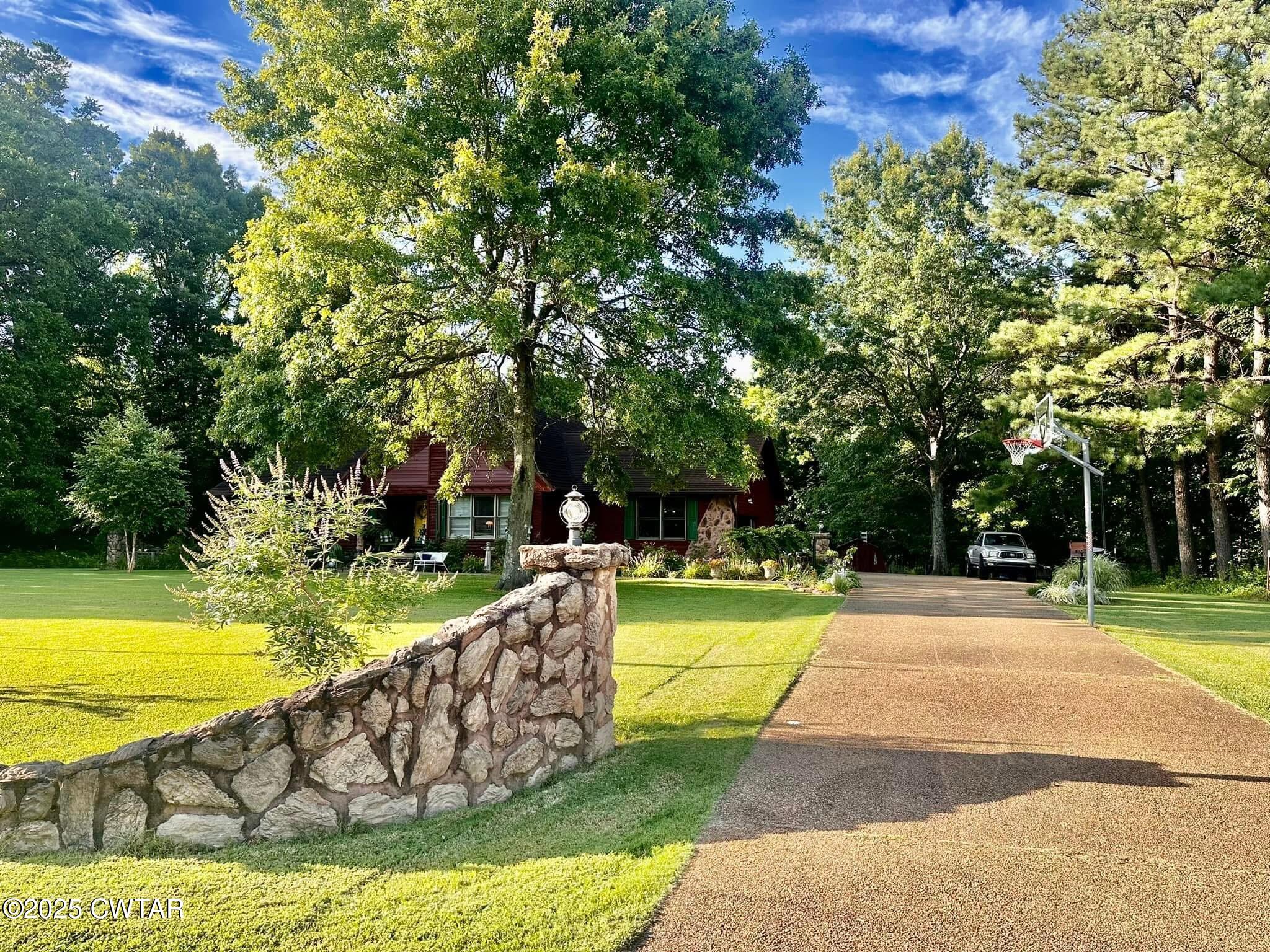 4310 Old Samburg Road Hornbeak, TN 38232 - Photo 17 of 20 a view of a swimming pool with a garden