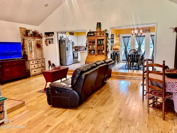 a living room filled with furniture and wooden floor