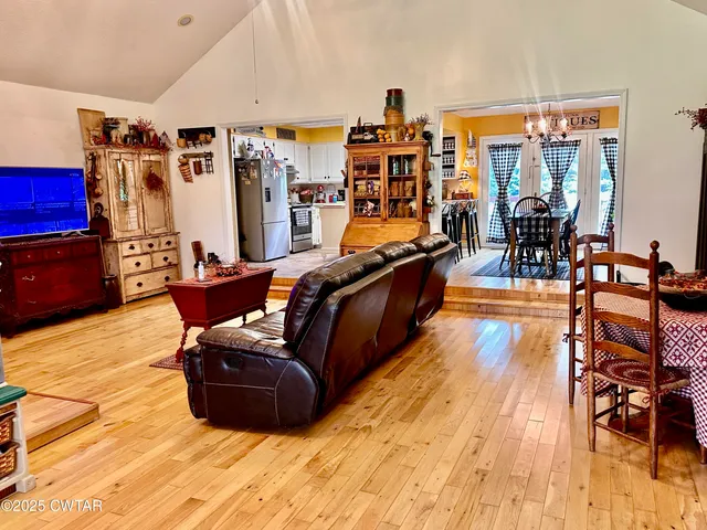 a living room filled with furniture and wooden floor