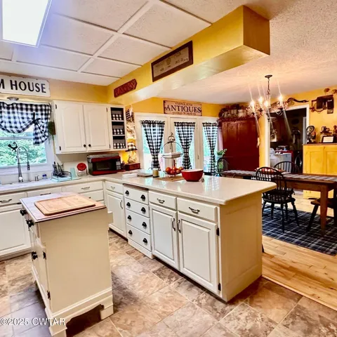 a kitchen with stainless steel appliances granite countertop a sink and a stove