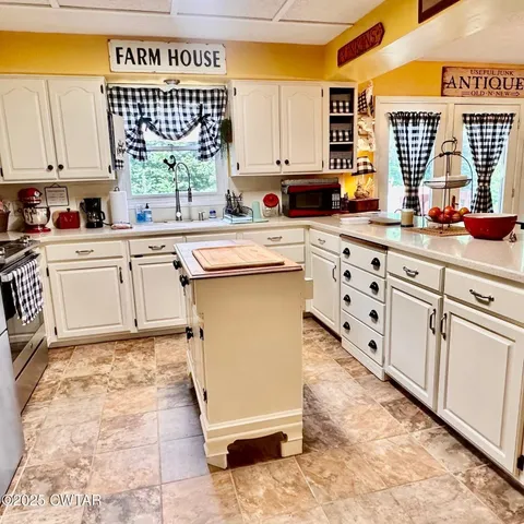 a kitchen with cabinets appliances and a counter top