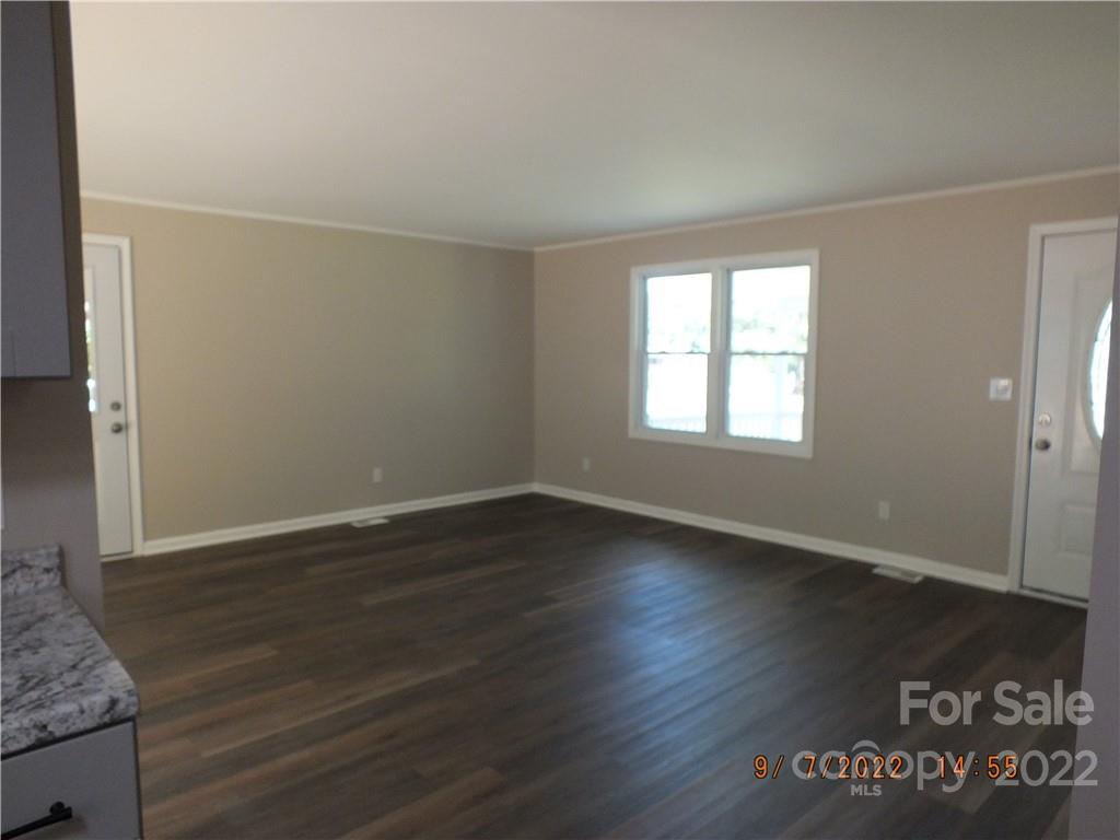 3177 Camp Creek Road Lancaster, SC 29720 - Photo 6 of 33 an empty room with wooden floor and windows