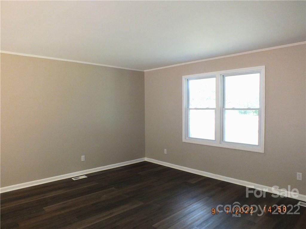 3177 Camp Creek Road Lancaster, SC 29720 - Photo 8 of 33 an empty room with wooden floor and windows