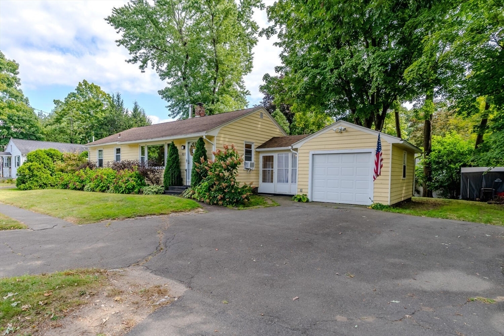 101 Bridge Road Northampton, MA 01062 - Photo 3 of 40 a front view of a house with a yard and garage