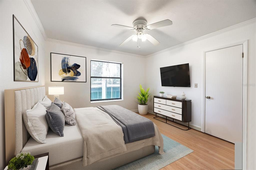 3811 Southwest 82nd Street Gainesville, FL 32608 - Photo 14 of 24 a bedroom with a bed and a flat screen tv