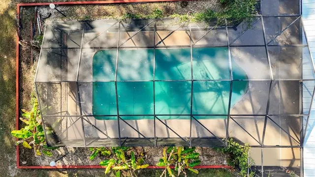 a view of a patio with a table and chairs under an umbrella