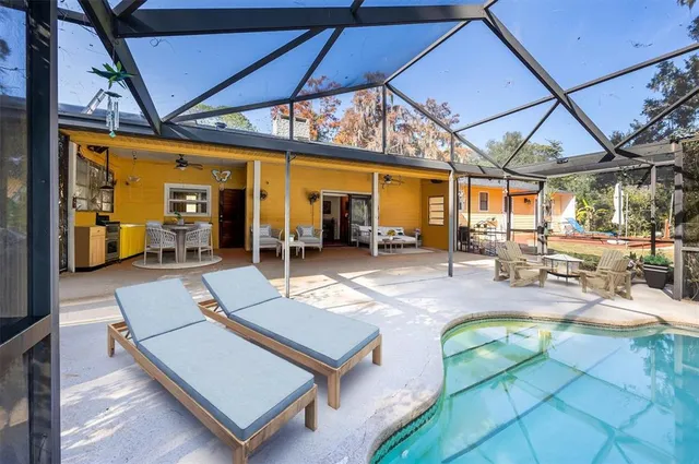 a view of a patio with a table and chairs under an umbrella
