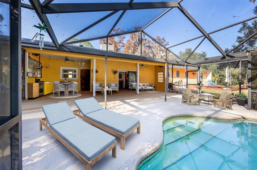 3811 Southwest 82nd Street Gainesville, FL 32608 - Photo 2 of 24 a view of a patio with a table and chairs under an umbrella