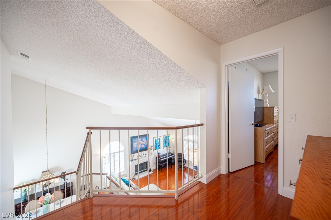 718 Rusty Spur Drive Henderson, NV 89014 - Photo 36 of 50 Hardwood floors lead to an open loft space overlooking the formal living area.