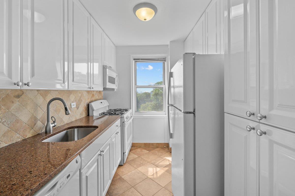 4525 Henry Hudson Parkway West, Unit 609 Bronx, NY 10471 - Photo 14 of 26 a kitchen with stainless steel appliances granite countertop a sink and a refrigerator