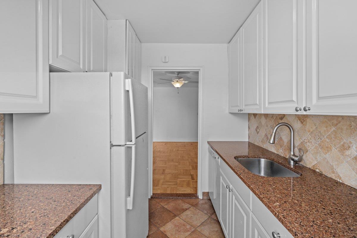 4525 Henry Hudson Parkway West, Unit 609 Bronx, NY 10471 - Photo 15 of 26 a kitchen with stainless steel appliances granite countertop a sink refrigerator and cabinets