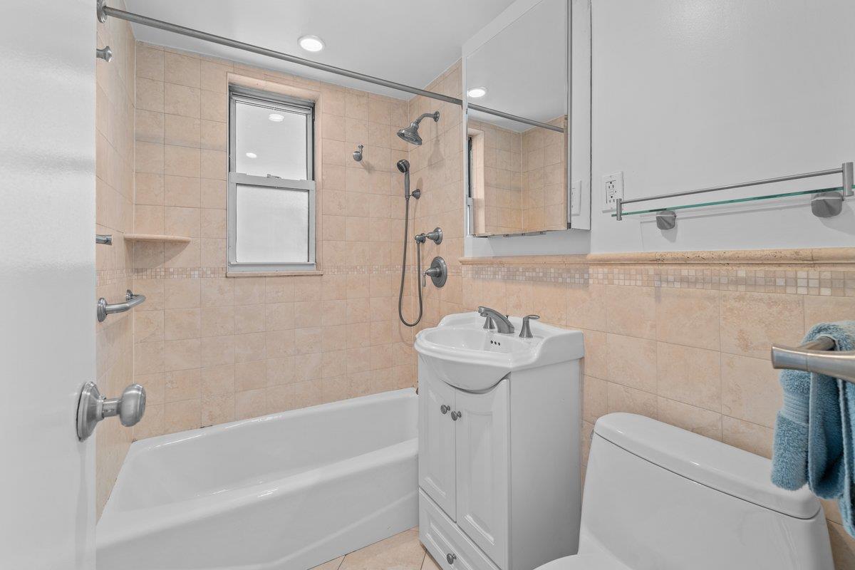 4525 Henry Hudson Parkway West, Unit 609 Bronx, NY 10471 - Photo 16 of 26 a bathroom with a sink a toilet and shower