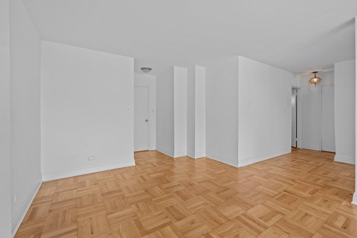 4525 Henry Hudson Parkway West, Unit 609 Bronx, NY 10471 - Photo 5 of 26 a view of a room with a wooden floor and a cabinet