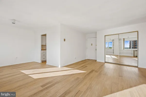 a view of a kitchen with wooden floor and a sink