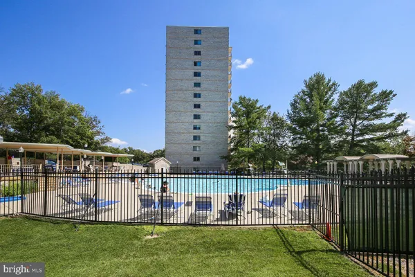 a view of a swimming pool with a yard