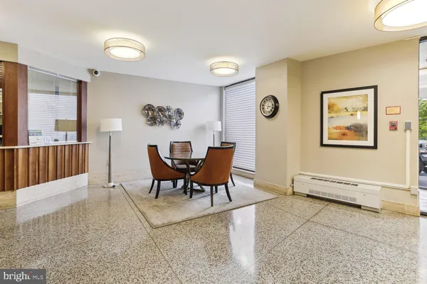 a living room with furniture and large windows
