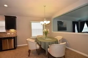 a dining room with furniture and window