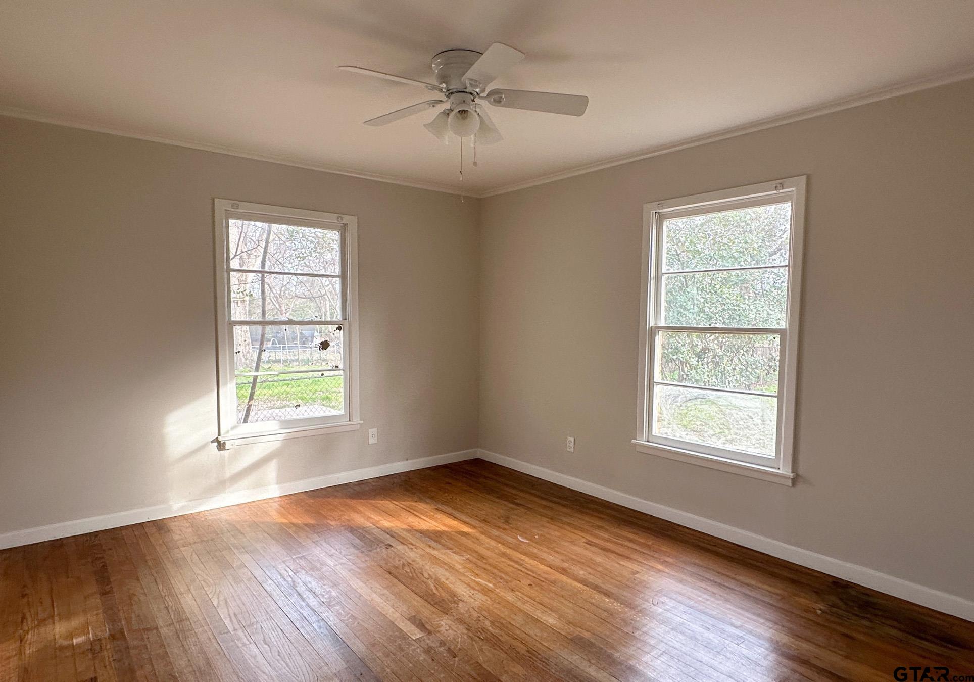 2331 Lingner Drive Tyler, TX 75701 - Photo 11 of 17 a view of an empty room with a window and wooden floor