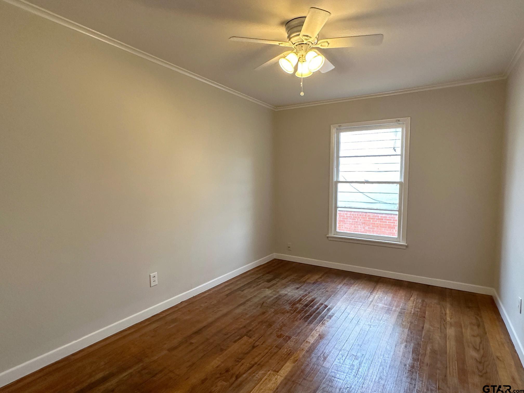 2331 Lingner Drive Tyler, TX 75701 - Photo 16 of 17 an empty room with wooden floor fan and windows