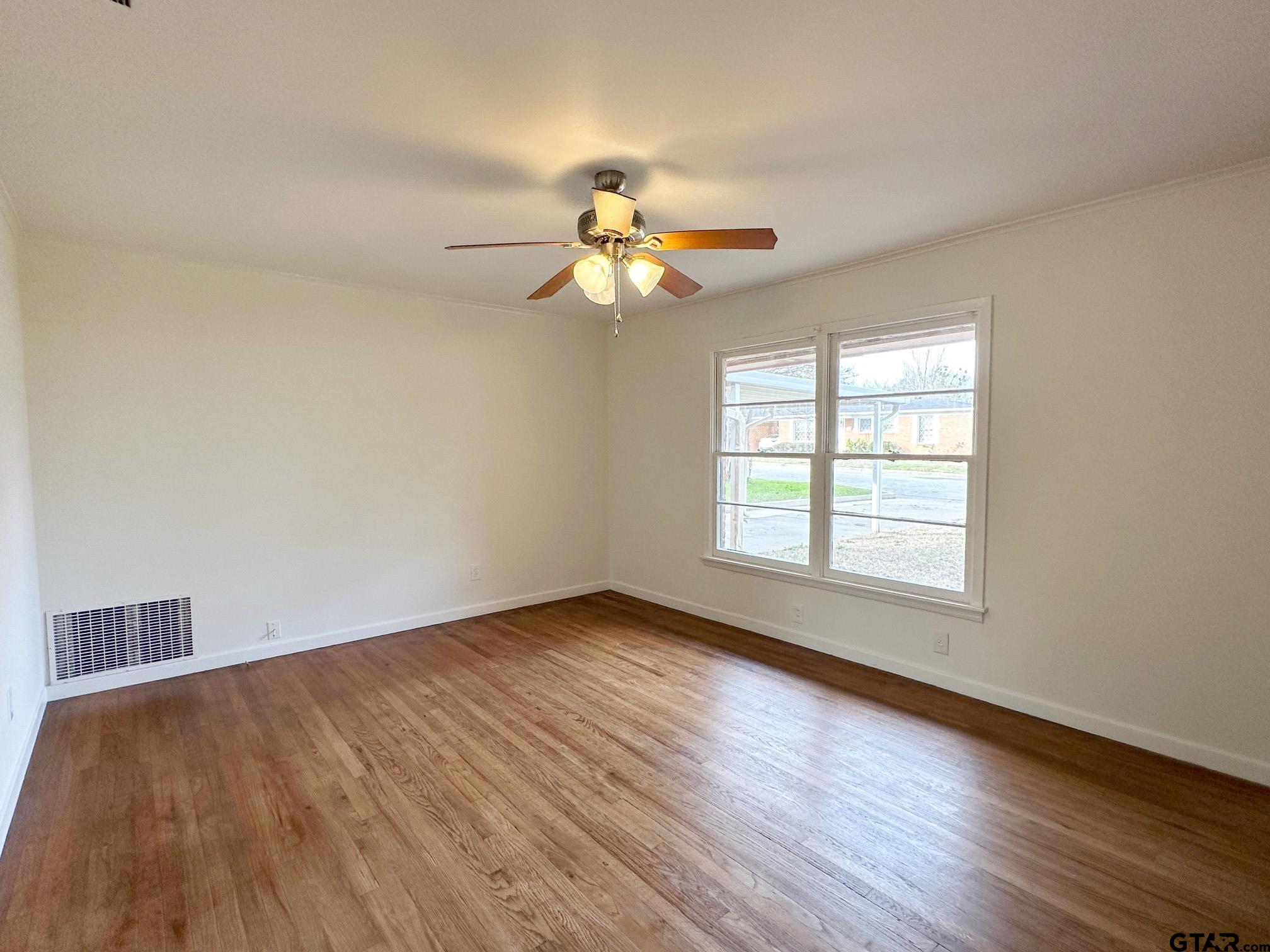 2331 Lingner Drive Tyler, TX 75701 - Photo 4 of 17 a view of room with window ceiling fan and wooden floor